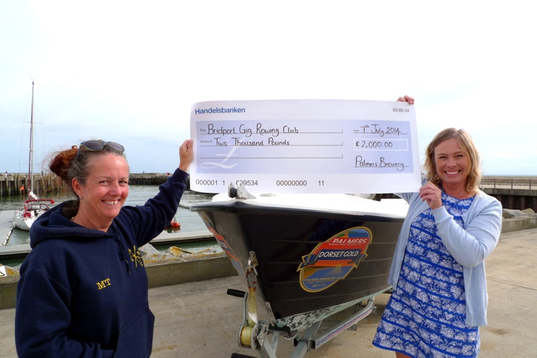 Suzanne Price, Palmers Accounts Manager, presents a cheque to Michelle Tiffin, Bridport Rowing Gig Club Captain.