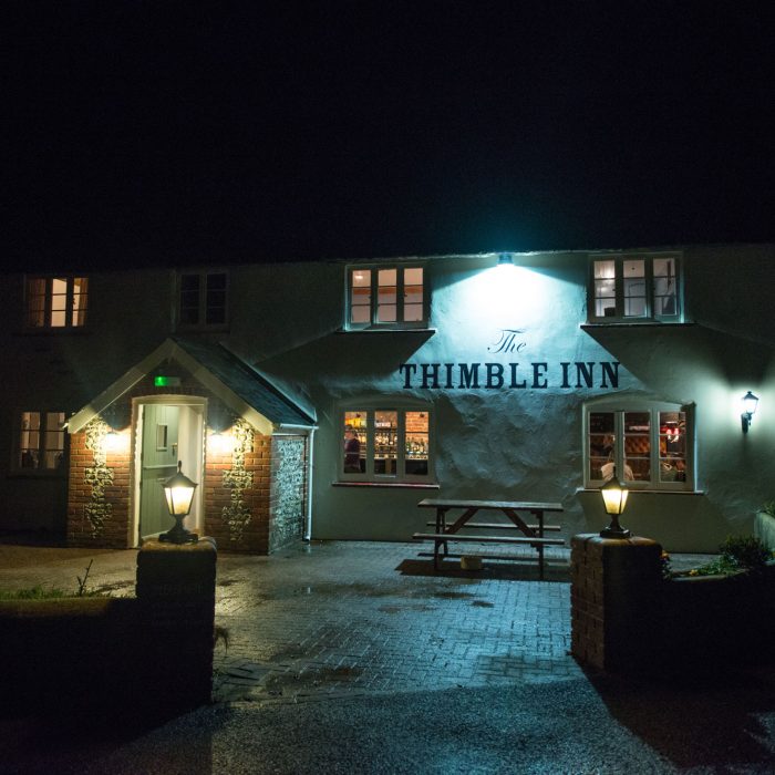 The Thimble Inn Piddlehinton, Dorset. Pub exterior at night.