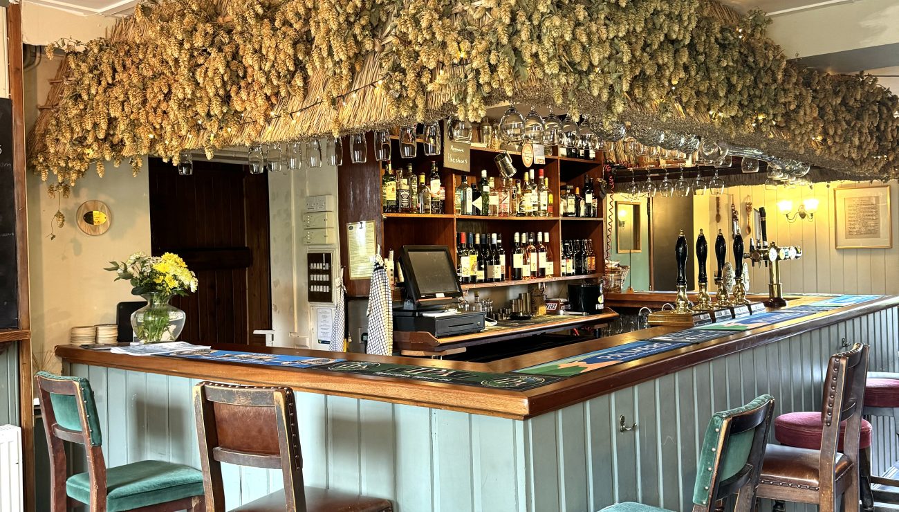 Stools at the bar of the Three Horseshoes Palmers pub